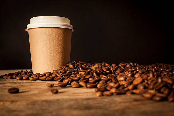 istock Paper cup of coffee on black background 627873712