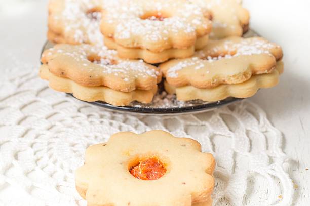 istock Homemade apricot jam Linzer with icing sugar on the white 627892880