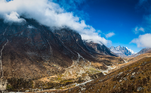 Traditional Sherpa farms high in the Thame valley of the Sagarmatha National Park surrounded by the snowy peaks and dramatic rocky pinnacles of the Himalayan mountains, Nepal.