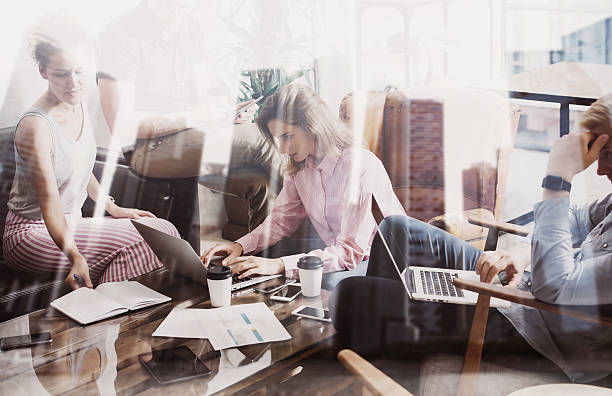 istock Young coworkers working together on new startup project in modern 627902454