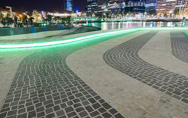 istock Green neon lights circulating underneath the stone seating 627904204