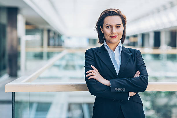 Trust in our business Young woman in business wear standing with armes crossed in business environment, with copy space. female role model stock pictures, royalty-free photos & images