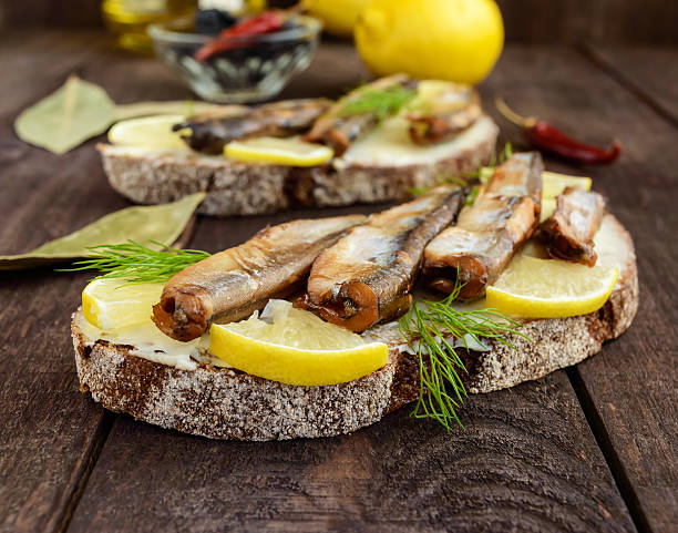 istock Sandwich with smoked fish capelin (sprats) 627909492