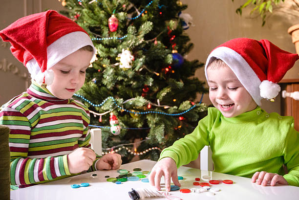 istock Kids brothers child boys making by hands x-mas decorations 627909664