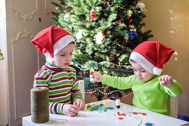 istock Kids brothers child boys making by hands x-mas decorations 627916414