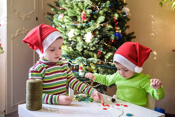 istock Kids brothers child boys making by hands x-mas decorations 627916496