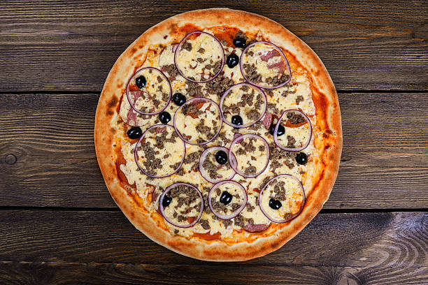 istock Delicious italian pizza served on wooden table 627916974