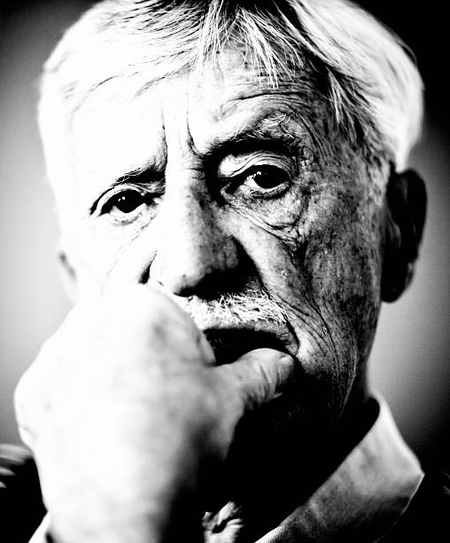 istock Wrinkled old man faces the world in black and white 627918446