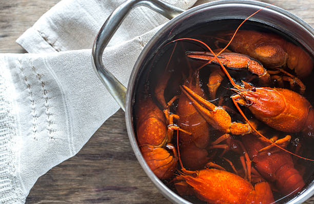 istock Pot with boiled crayfish on the wooden table 627918608