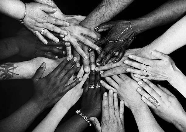 Hands together Male and female hands of various ethnicities all together. Monochrome. equality stock pictures, royalty-free photos & images