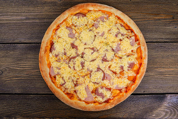 istock Delicious italian pizza served on wooden table 627919092