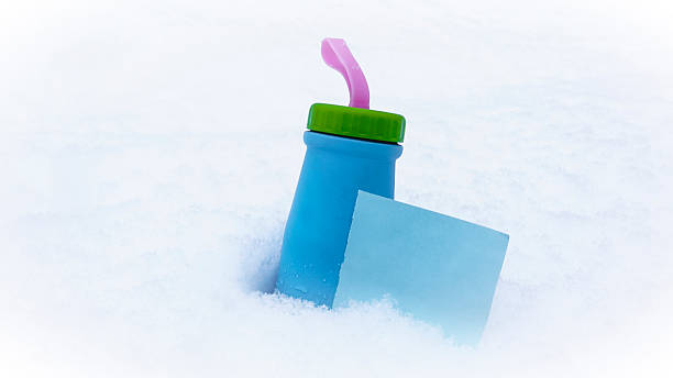 istock Tea bottles in snow, white snow, words on paper 627920480