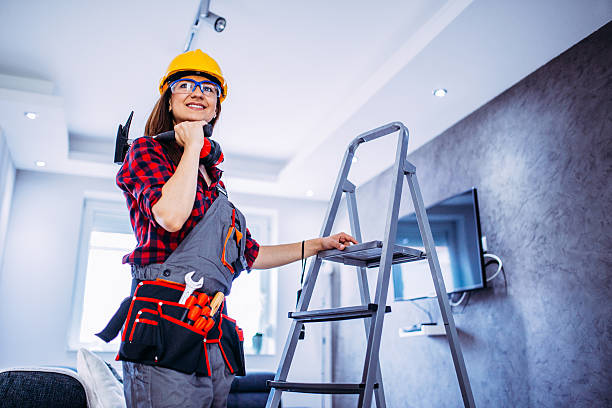 Done with repairing Young female construction worker, repairing stuff at home, alone by herself. woman wearing tool belt stock pictures, royalty-free photos & images