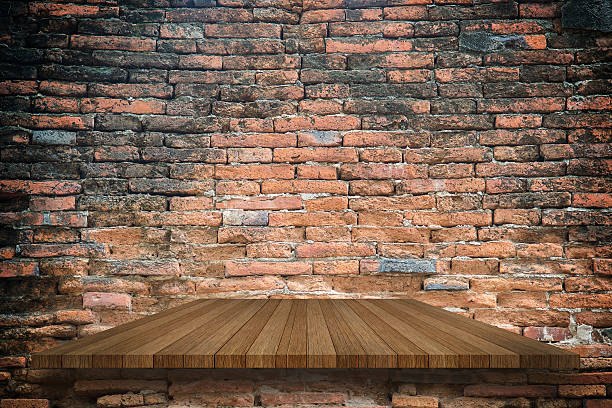 istock Empty top of wooden shelves on ancient brick wall 627923114