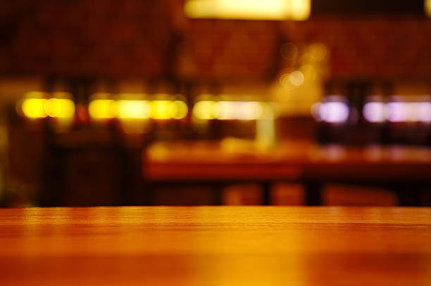 istock wood top table with blur light cafe background abstract 627923248