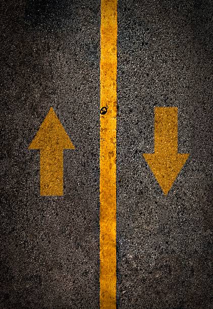 istock Yellow line on the high way with arrow. 627929712