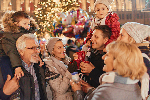 Family on Christmas market Photo of a cheerful family, celebrating Christmas Holidays on Christmas market multi generation family christmas stock pictures, royalty-free photos & images