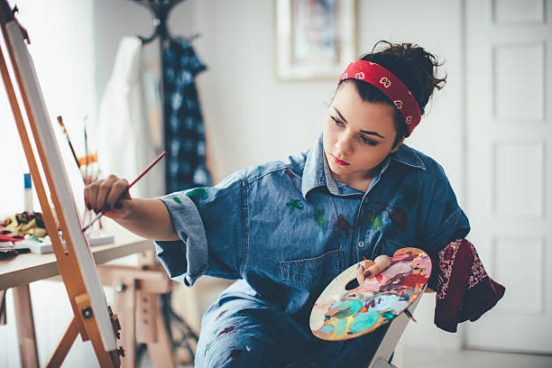 istock Young girl paints on canvas 627932430
