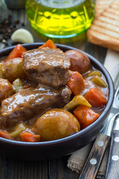 istock Hearty beef stew with carrot, celery, shallot and potato, vertical 627932490