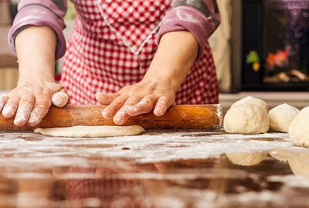 istock Grandma kneading and stretching the dough at home 627932572