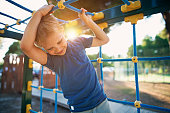 Little boy climbing on the playground