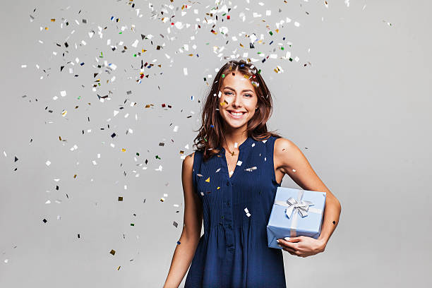 istock Laughing girl with falling confetti at party 627933752