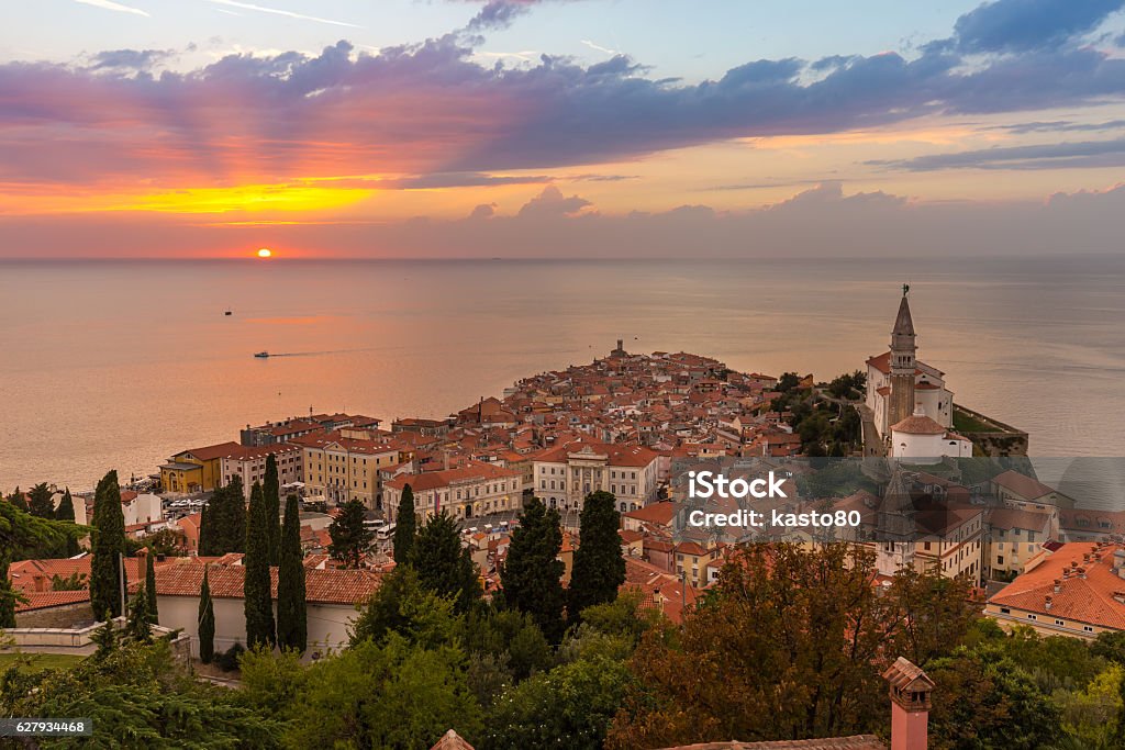 Romantic colorful sunset over picturesque old town Piran, Slovenia. Romantic colorful sunset over picturesque old costal town Piran, Slovenia. Senic panoramic view. Piran Stock Photo