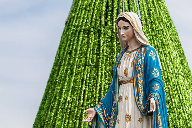 istock The Virgin Mary Statue with Christmas Tree Background. 627940586