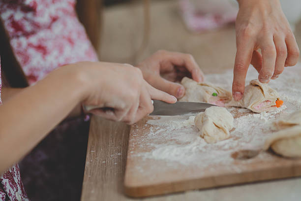 istock Mother with her daughter are preparing the buns 627942706