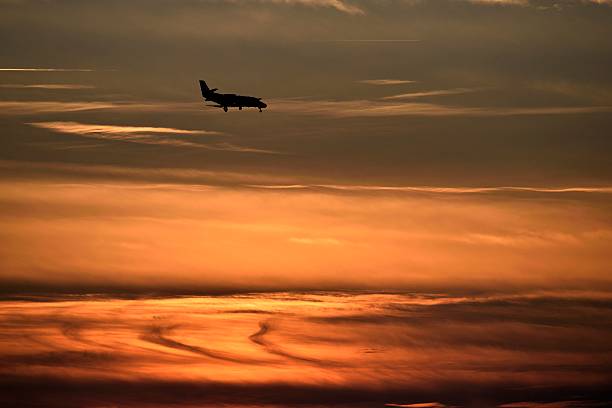 istock Airplane landing at Sunset 627942728
