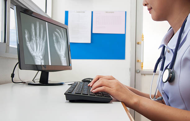 Doctor working with computer at desk in the hospital