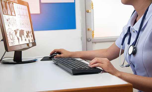 istock Doctor working with computer at desk in the hospital 627943436