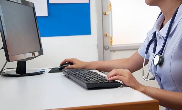 Doctor working with computer at desk in the hospital