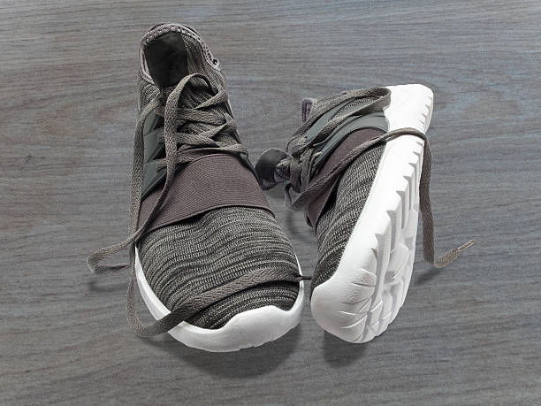 istock Sneakers on a wooden background. 627950480