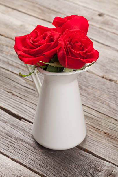 istock Red rose flowers in pitcher 627950588