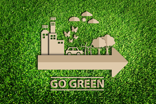 Paper cut of Green city concept on green grass