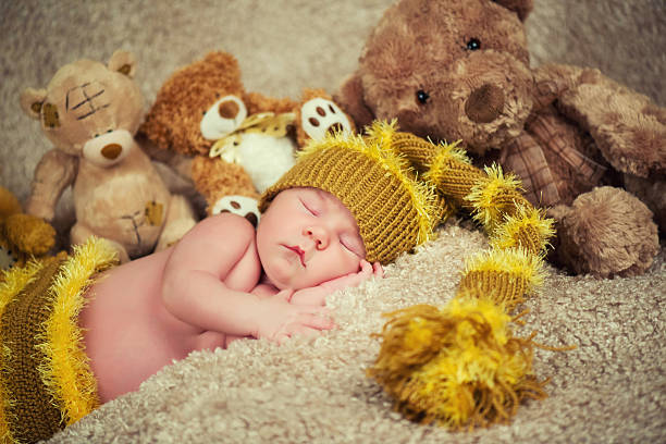 istock Newborn baby sleeping on toys background. 627958042