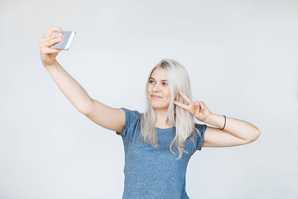 istock Pretty hipster girl taking selfie and smiling. 627965362