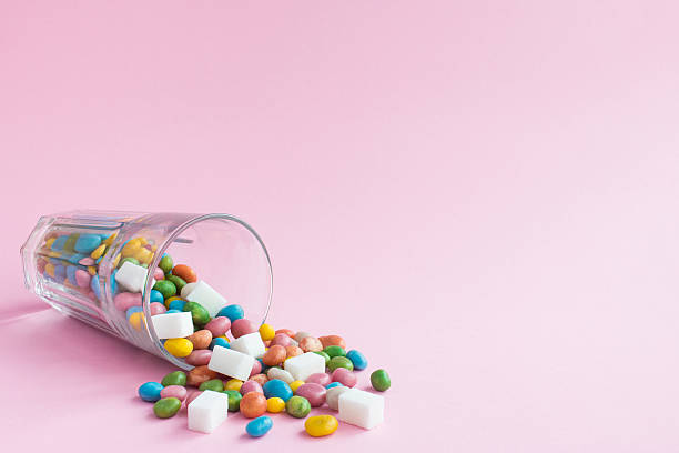 istock Glass candy on pink background. Sugar cocktail 627965770