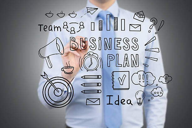istock Man drawing a business plan sketch on a glassboard 627966660
