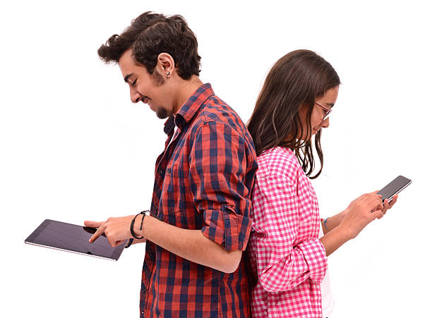 Young boy and little girl using smart phone and tablet pc Sister and brother using devices, isolated on white. two kindle phones stock pictures, royalty-free photos & images