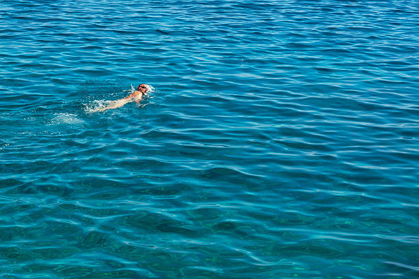 istock Bearded man is swimming in sea 627967670