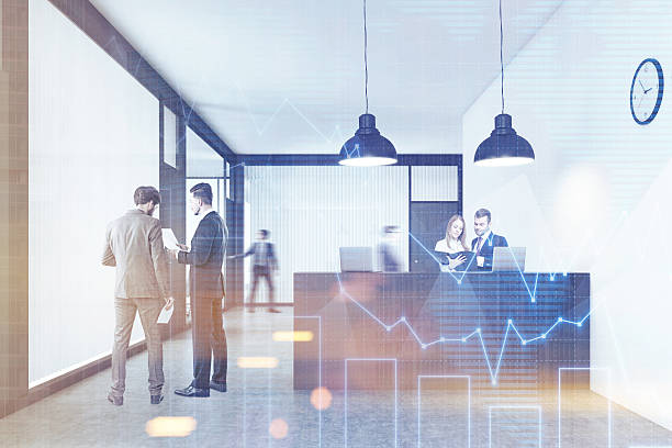 istock People talking and walking near the reception desk with graphs 627968144