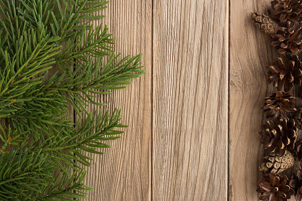 istock Christmas tree and cones on the wooden table 627968360
