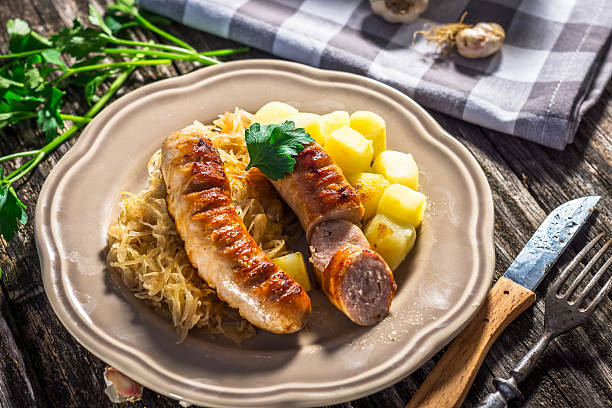 istock Grilled sausages,  potatoes and sauerkraut 627968450