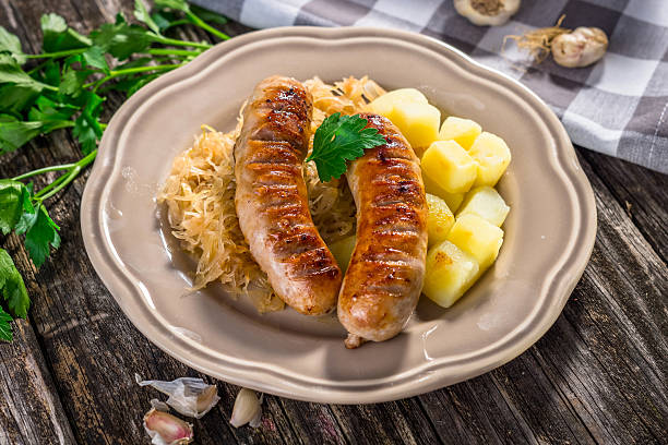 istock Grilled sausages,  potatoes and sauerkraut 627968710