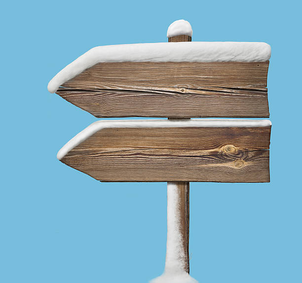 istock Wooden direction sign with less snow on blue. two_arrows-one_dir 627975660
