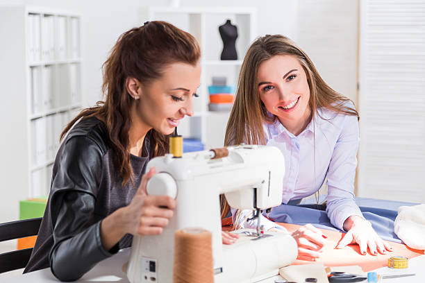 istock Woman sewing with a colleague by her side 627975958