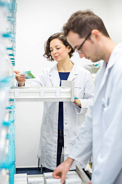 istock Two pharmacists looking for prescription medication 627976536