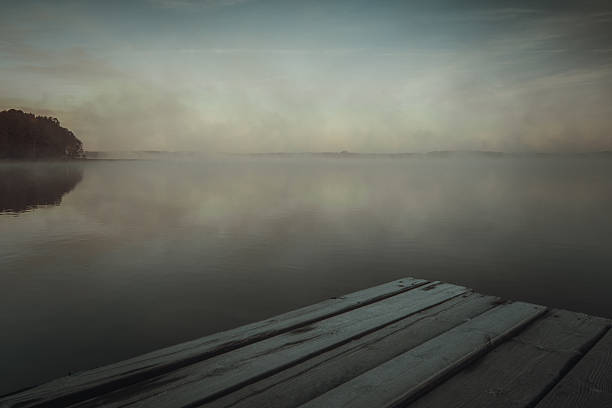 istock first rays of dawn sunlight in the lake. 627976784